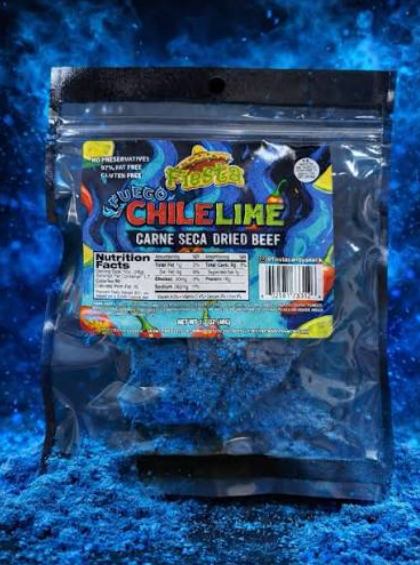 A clear plastic stand-up pouch of Fuego's 'Nuebo Chile Lime' carne seca dried beef, featuring a colorful label with red, yellow, and blue graphics, set against a textured blue background.